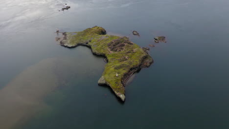 aerial view of a small, green island in the water