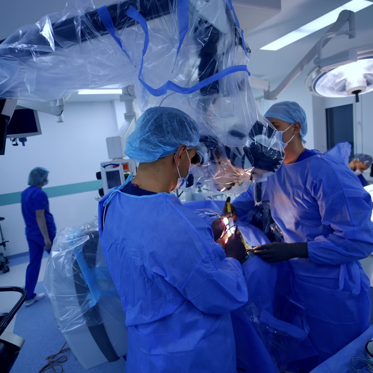 Technologically equipped modern surgery room for neurology operations. Two surgeons using advanced microscope and innovative devices at work