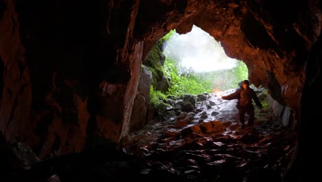 adventurer exploring a dark cave with a torch