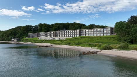 presenting hotel helnan marselis beachfront resort in aarhus denmark - slow moving low altitude aerial from seaside