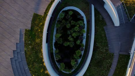 aerial view, sunrise over the green-roofed musée de la romanité filled with grass and trees