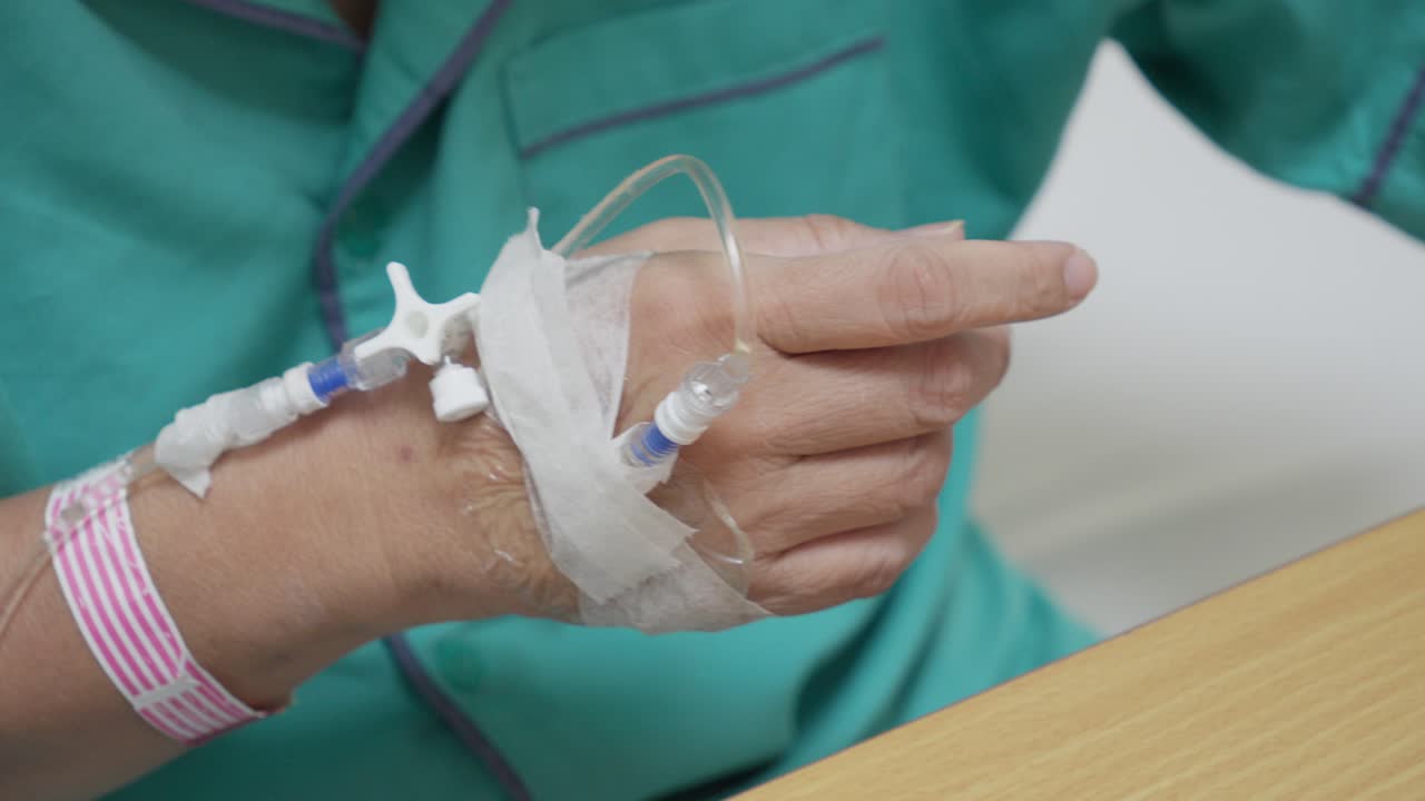 Hand with intravenous drip in hospital, soft focus, medical treatment, recovery scene