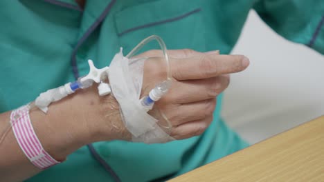 hand with intravenous drip in hospital, soft focus, medical treatment, recovery scene