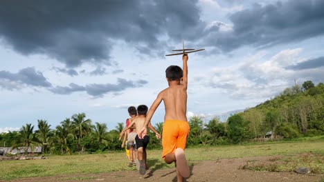 kids playing with paper airplanes outdoors