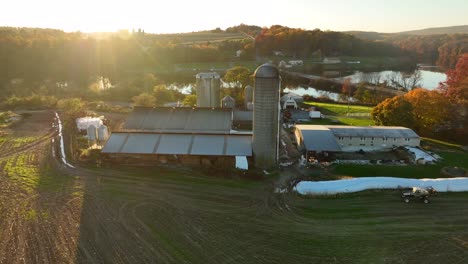 American-farm-beside-rural-lake-at-autumn-sunset