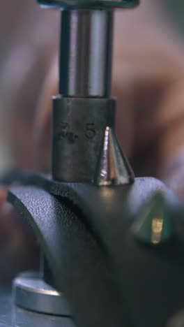 cu: professional worker sets stylish leather choker accessories with special press machine extreme close view