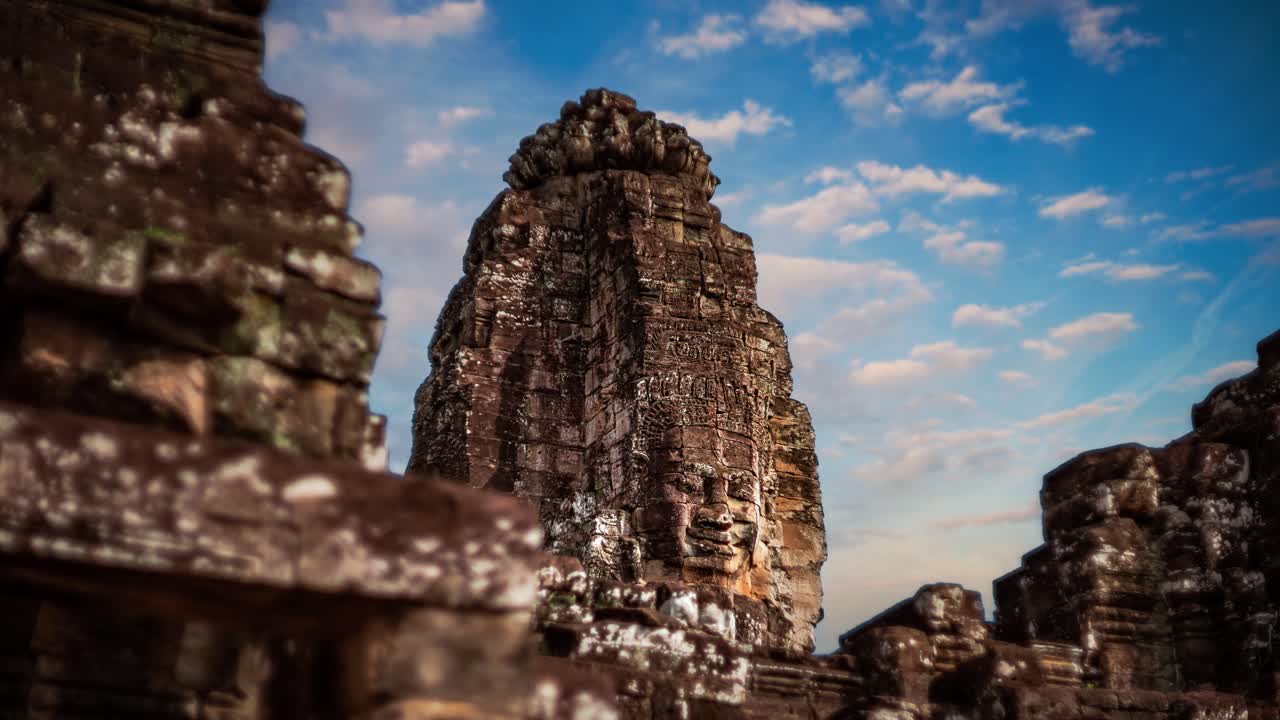 Smiling stone faces of Bayon Temple time lapse. Angkor Wat, Cambodia. Moving clouds across the sky