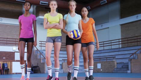 female players standing with volleyball in the court 4k