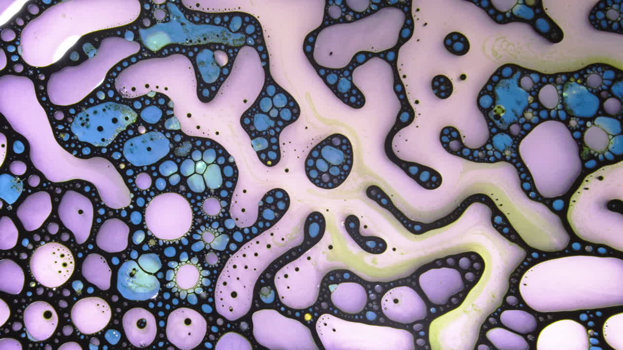 Colorful liquid bubbles mixing with macro shot of fluid .movements and textures