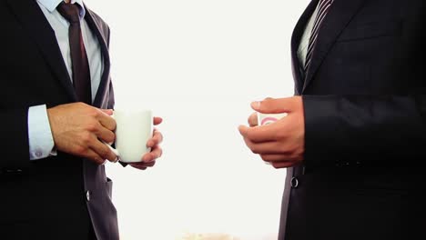 close shot of hands of businessman holding people drinking from cups