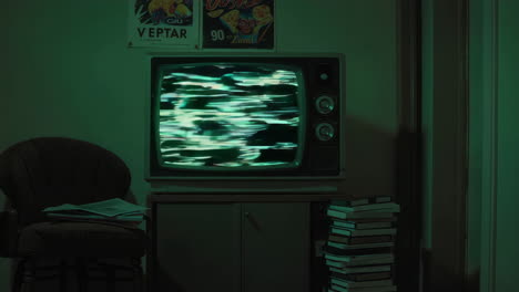 vintage tv with green static in a retro room