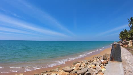 wide-angle view of blue sky white sand beach in clear air sunny day. a white seagull fly through the clear blue sky. tourism in tropical paradise southern sea in thailand. water waves ripple on shore