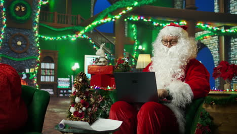 santa claus working on a laptop