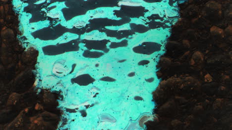 turquoise water pool with stone edge