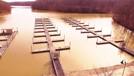 Aerial-footage-of-boat-slips-at-a-marina-on-an-icy-lake-during-the-winter-at-a-state-park