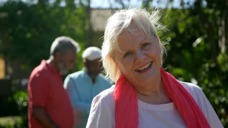 Front-view-of-active-Caucasian-senior-woman-smiling-in-the-garden-of-nursing-home-4k