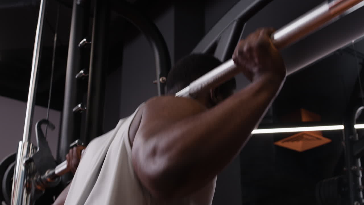 Man performing a shoulder press exercise in the gym
