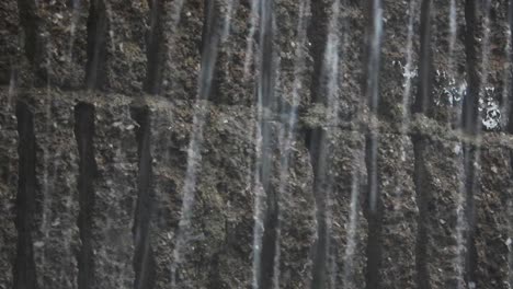 Rain-drops-and-hailstones-falling-and-dripping-on-plaster-and-building-bricks-during-a-thunderstorm