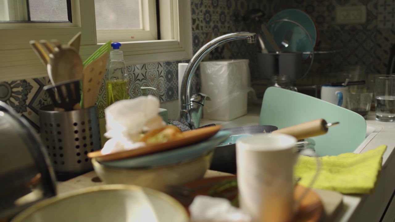 Panning over dirty dishes in the kitchen sink