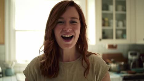 capturing the joy of everyday moments: a young woman transitions from reflective calmness to radiant happiness in a warm kitchen environment