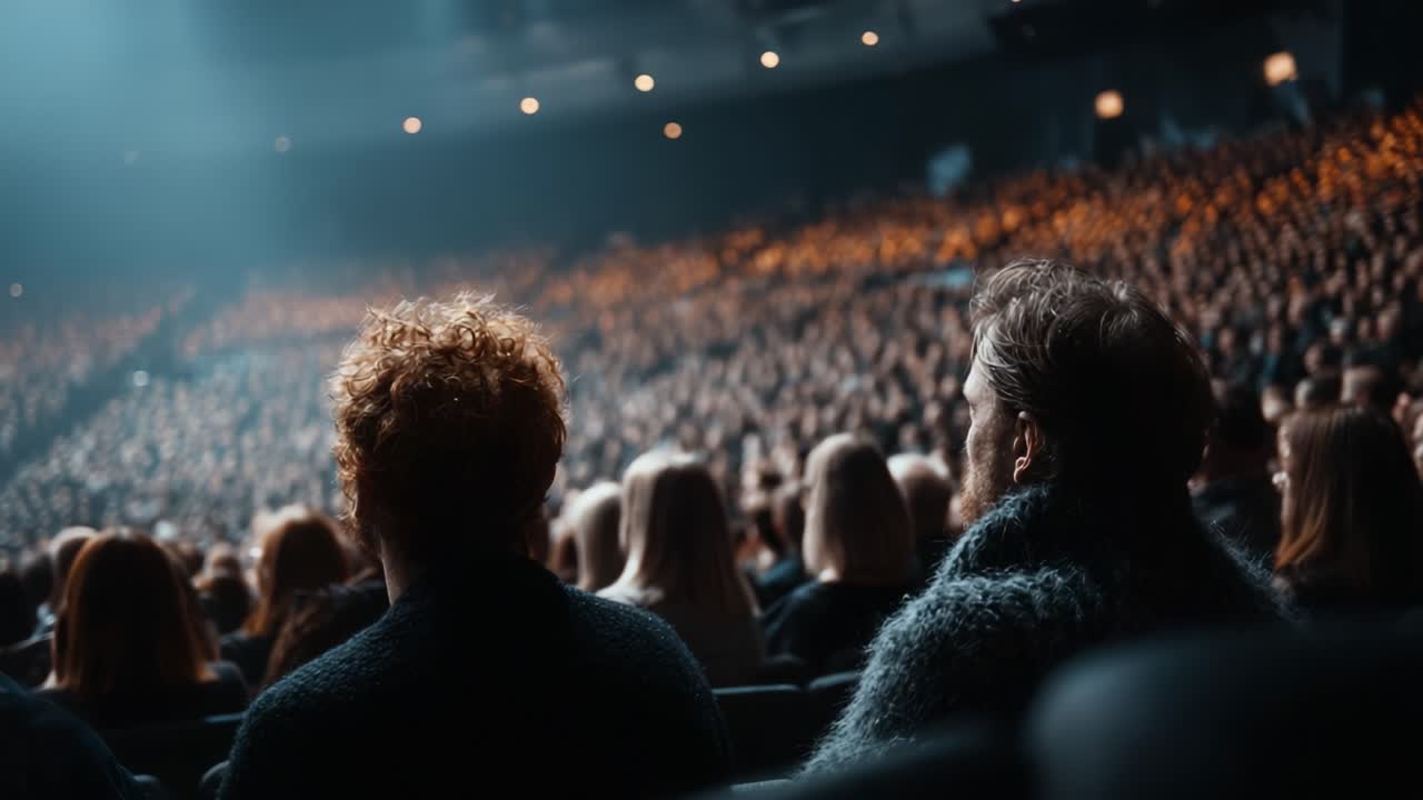 A captivating scene of an enthralled audience captured at a live performance, showcasing the mesmerizing atmosphere and vibrant energy of a crowd in anticipation