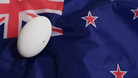 White-rugby-ball-over-waving-flag-of-australia-with-copy-space,-in-slow-motion