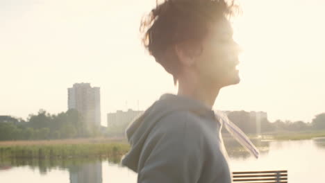 Woman-In-Sportswear-Running-Along-City-Riverside-Promenade-In-The-Morning-At-Sunset