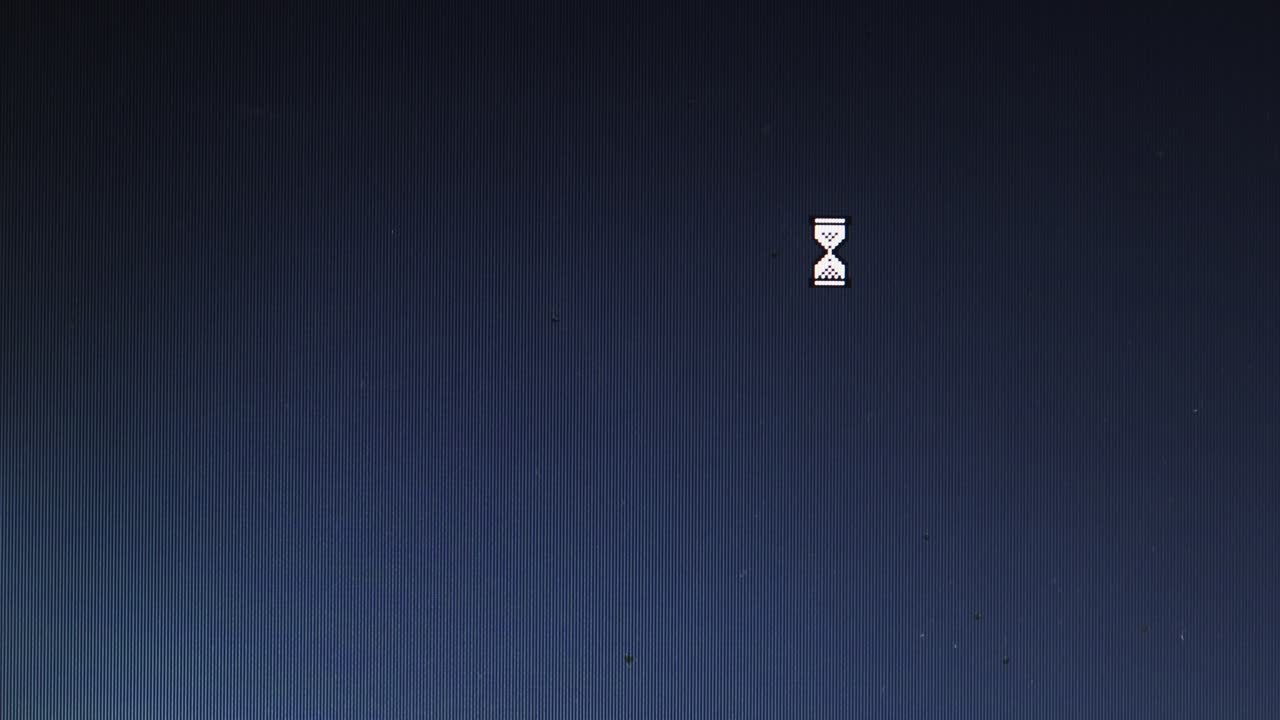 Egg timer and mouse cursor icons appear on blue pc screen interface