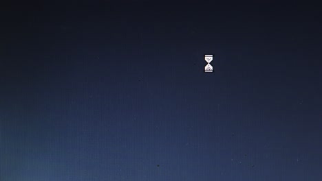 egg timer and mouse cursor icons appear on blue pc screen interface