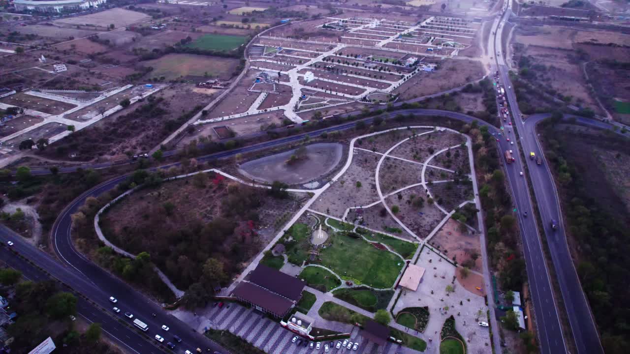 Oxygen Bird Park with outer ring road at Jamtha, nagpur, Maharashtra, india. sun set time, circle shot, drone shot, 4k.