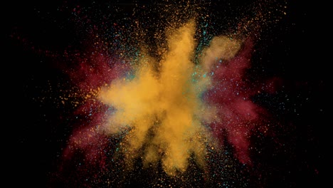 super slow motion of colored powder explosion isolated on dark background.