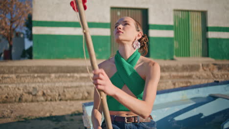 woman holding fishing rod on summer weekend. fashion model resting river boat