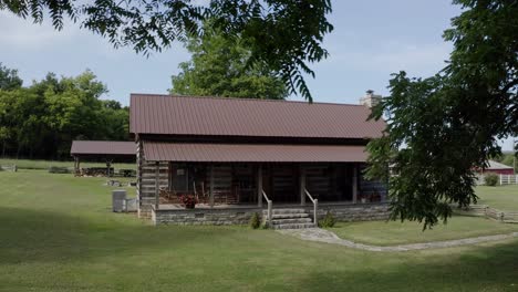 Umlaufende-Antenne-Um-Rustikales-Blockhaus-Umgeben-Von-Idyllischer-Landschaft,-4k