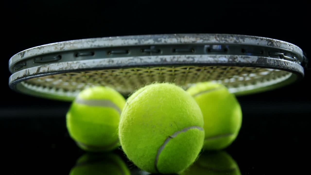 Tennis balls and racket in studio 4k