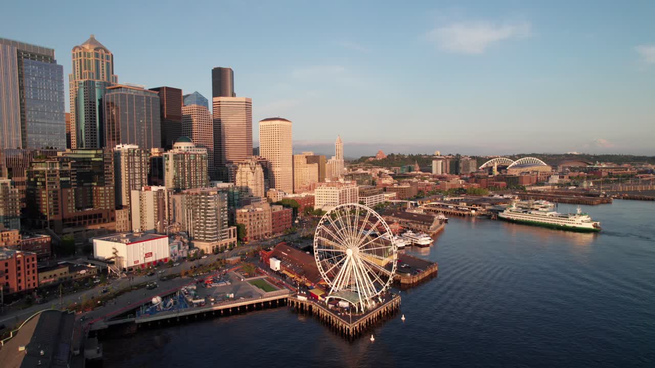 Seattle waterfront, long aerial shot. Great Wheel and Pike's Place market at sunset. 4K