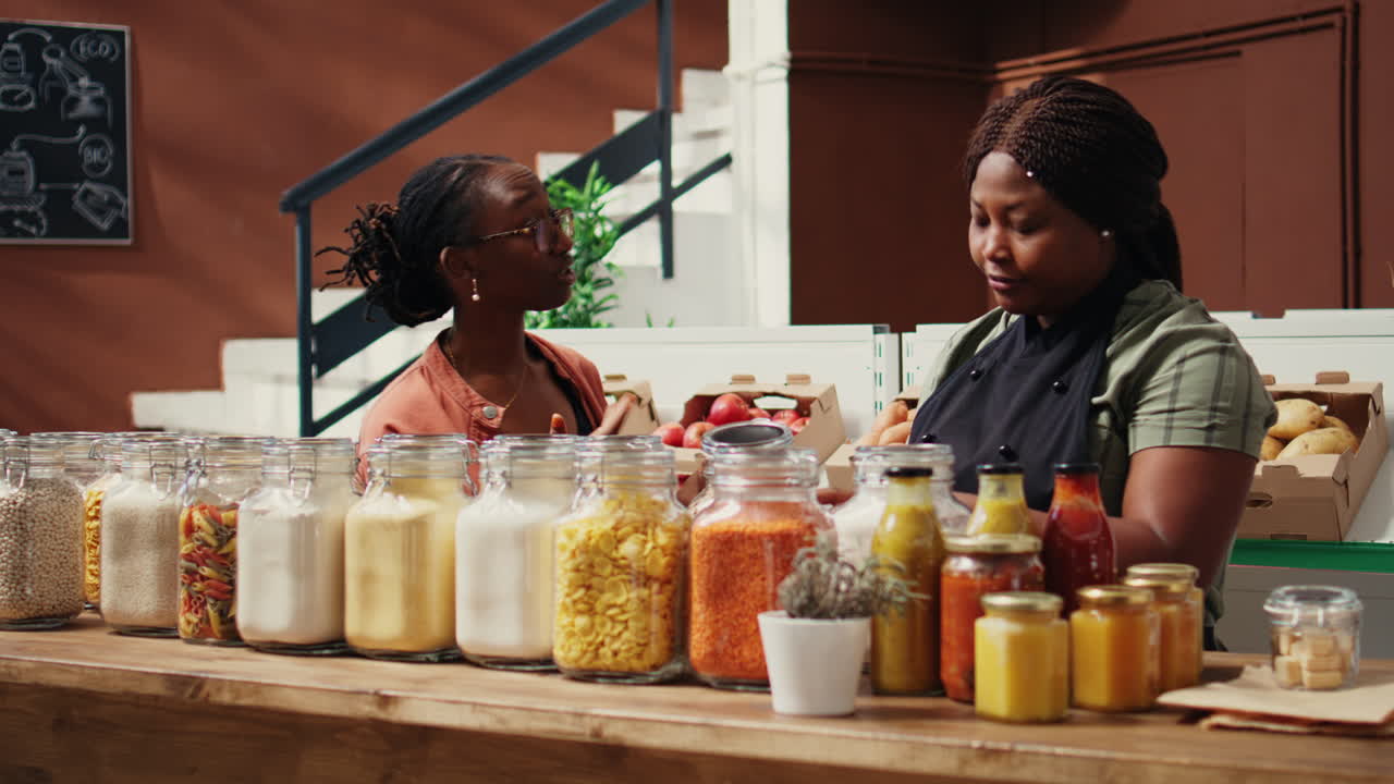 African american seller giving food sample to customer