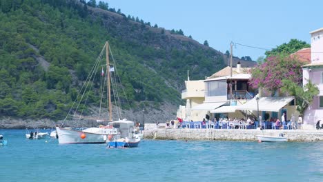 greek island harbor with boats and restaurant