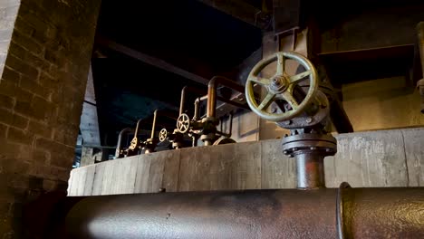 several steel valves are threaded between pipes at metallurgical plant in the city of monterrey, nuevo leon