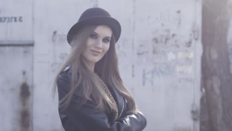 stylish woman in a black hat and leather jacket