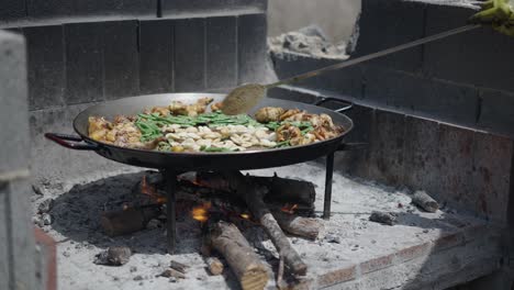 cooking paella over an open fire