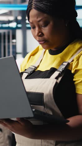 vertical video photovoltaics factory engineer using laptop to do performance testing