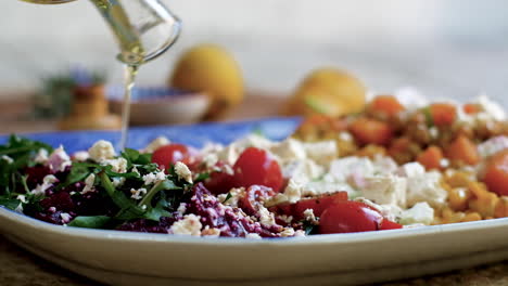 olive oil drizzled over fresh mediterranean salad