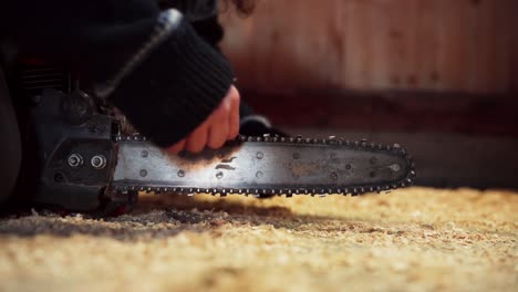 man cleaning chainsaw chain with stick. closeup shot