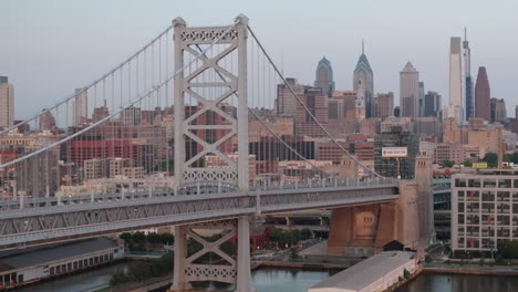 aerial view of philadelphia's ben franklin bridge. shot along the delaware river at sunrise on a summer morning
