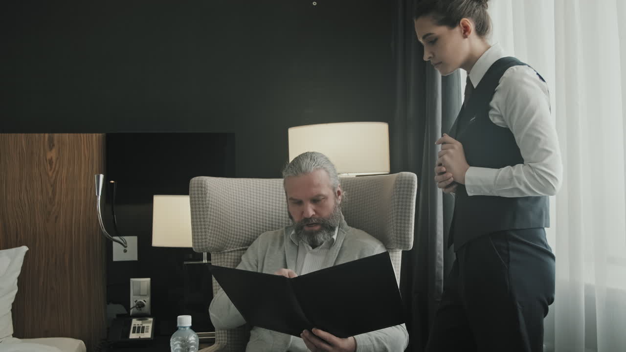 Businessman Ordering Dinner in Hotel Room