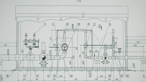 hand pointing at an engineering blueprint