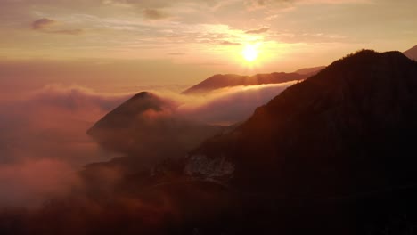 AERIAL---Beautiful-sunrise-in-the-mountains-at-Lake-Skadar,-Montenegro,-backward