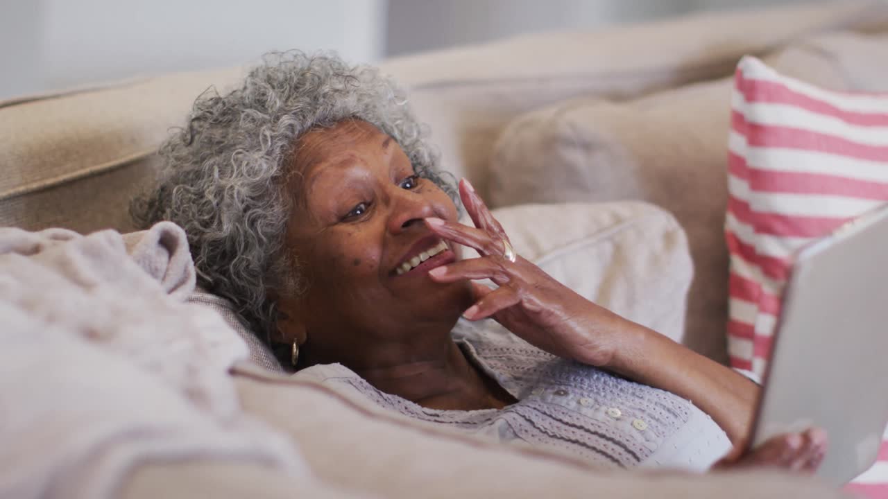 Senior african american woman having a video call on digital tablet at home