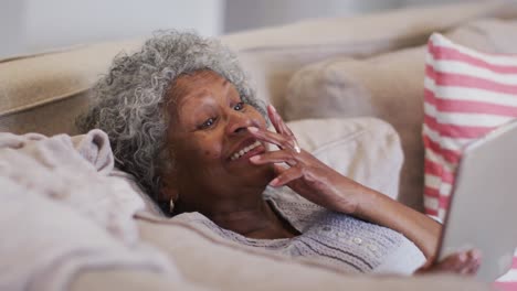 senior african american woman having a video call on digital tablet at home