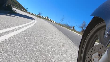 Motorcycle-Riding-in-Curvy-Twisty-Countryside-Road,-Front-Wheel-Side-View-from-the-Left,-Time-Warp-Video